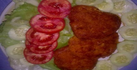 Salt fish fritters on salad plate